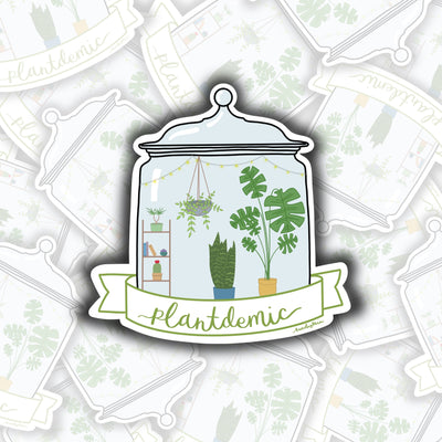 the outline of a sticker is a lidded glass jar. inside the glass jar is filled with five different plants inside. on the left is a bookshelf with a plant on top, books in the middle, and a plant on the bottom. in the middle of the sticker is a hanging potted plant and a plant standing on the ground. on the right is a large plant standing on the ground as well. the bottom of the sticker has text in a banner that says "plantdemic"
