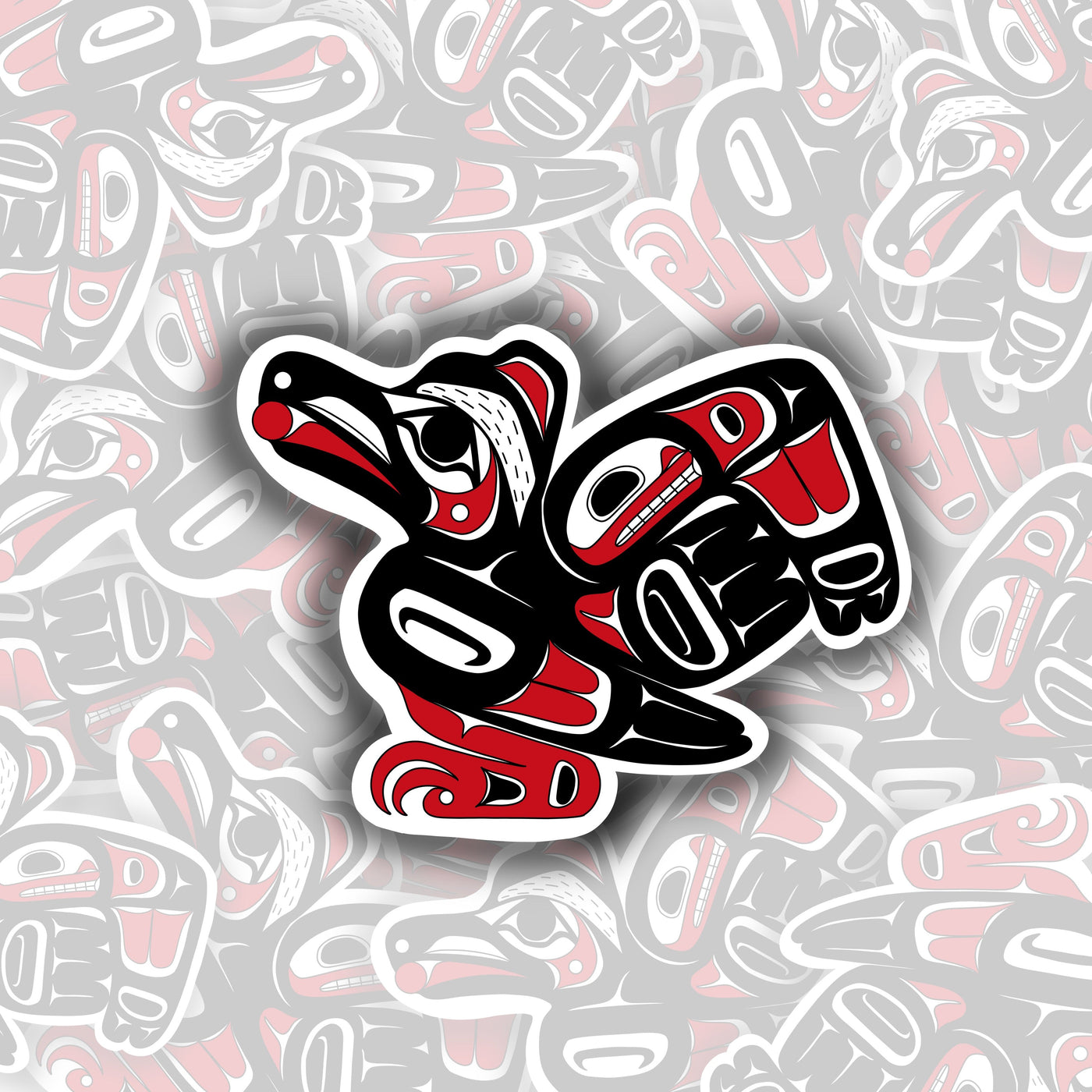 Black raven with red accents on the wing, body, face, and feet. inside of the raven's mouth is a small red circle representing the sun.