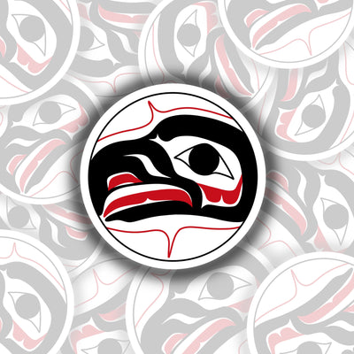 Round sticker with a formline drawing of an eagle head. the eagle is facing the left. it is all black with a red tongue and accents.